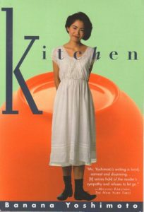 Book Cover for Kitchen, with a woman in a white dress standing shyly, with her arms behind her back.